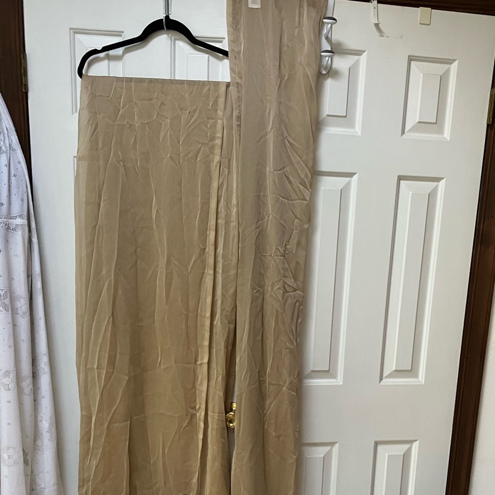 One pair long taupe/tan sheer drapery. 86”long. Ea half is 42” wide, x2=84”wide.